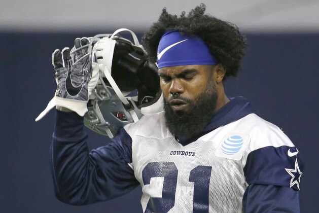 Dallas Cowboys running back Ezekiel Elliott (21) walks the field during an organized team activity at its NFL football training facility in Frisco, Texas, Wednesday, May 29, 2019. (AP Photo/Ron Jenkins)