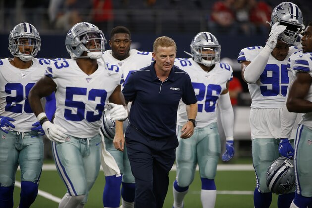 Dallas Cowboys' Justin March-Lillard (53), Jason Garrett and others jog off the field before a preseason NFL football game against the Tampa Bay Buccaneers in Arlington, Texas, Thursday, Aug. 29, 2019. (AP Photo/Ron Jenkins)
