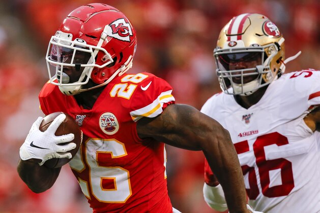 KANSAS CITY, MO - AUGUST 24: Damien Williams #26 of the Kansas City Chiefs runs past Kwon Alexander #56 of the San Francisco 49ers for a 62-yard touchdown catch in the first quarter of a preseason game at Arrowhead Stadium on August 24, 2019 in Kansas City, Missouri. (Photo by David Eulitt/Getty Images)