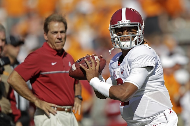 Alabama quarterback Jalen Hurts (2) warms up before an NCAA college football game against Tennessee as Alabama head coach Nick Saban watches Saturday, Oct. 15, 2016, in Knoxville, Tenn. (AP Photo/Wade Payne)