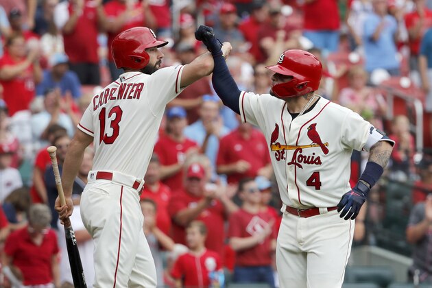 St. Louis Cardinals' Yadier Molina (4) is congratulated by teammate Matt Carpenter (13) after hitting a solo home run during the third inning in the first baseball game of a doubleheader against the Cincinnati Reds, Saturday, Aug. 31, 2019, in St. Louis. (AP Photo/Jeff Roberson)
