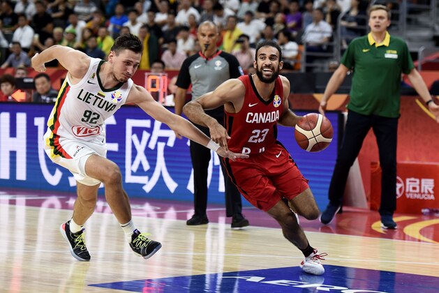 Canada's Phil Scrubb (R) dribbles past Lithuania's Edgaras Ulanovas during the Basketball World Cup Group H game between Lithuania and Canada in Dongguan on September 3, 2019. (Photo by Ye Aung Thu / AFP)        (Photo credit should read YE AUNG THU/AFP/Getty Images)