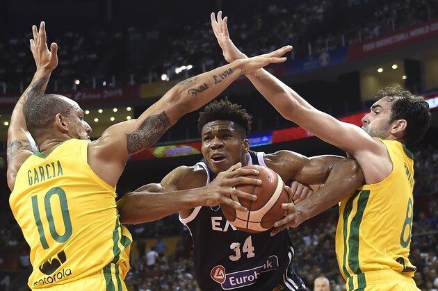 Greece's Giannis Antetokounmpo (C) tries to handle the ball through Brazil's Alex Garcia (L) and Brazil's Vitor Benite during the Basketball World Cup Group F game between Brazil and Greece in Nanjing on September 3, 2019. (Photo by WANG ZHAO / AFP)        (Photo credit should read WANG ZHAO/AFP/Getty Images)