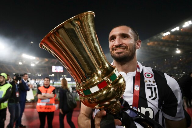 Juventus' defender from Italy Giorgio Chiellini celebrates with the trophy at the end of the Italian Tim Cup (Coppa Italia) final Juventus vs AC Milan at the Olympic stadium on May 9, 2018 in Rome. - Juventus crushed AC Milan 4-0 on today at the Stadio Olimpico to win a fourth consecutive Italian Cup. Mehdi Benatia opened the floodgates after 56 minutes for the first of a double of the night for the Moroccan with Douglas Costa also finding the net in the space of nine minutes. A Nikola Kalinic own goal accounted for the fourth (Photo by Isabella Bonotto / AFP) (Photo credit should read ISABELLA BONOTTO/AFP/Getty Images) Juventus' defender from Italy Giorgio Chiellini celebrates with the trophy at the end of the Italian Tim Cup (Coppa Italia) final Juventus vs AC Milan at the Olympic stadium on May 9, 2018 in Rome. - Juventus crushed AC Milan 4-0 on today at the Stadio Olimpico to win a fourth consecutive Italian Cup. Mehdi Benatia opened the floodgates after 56 minutes for the first of a double of the night for the Moroccan with Douglas Costa also finding the net in the space of nine minutes. A Nikola Kalinic own goal accounted for the fourth (Photo by Isabella Bonotto / AFP) (Photo credit should read ISABELLA BONOTTO/AFP/Getty Images)
