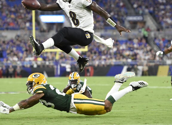 FILE - In this Aug. 15, 2019, file photo, Baltimore Ravens quarterback Lamar Jackson (8) leaps over Green Bay Packers cornerback Jaire Alexander (23) during the first half of a NFL football preseason game, in Baltimore. Given the many variables that go into developing an elite quarterback, Pro Football Hall of Famer Jim Kelly can't even imagine assessing what to make of last year's group of five first-round draft picks as they enter their sophomore seasons. (AP Photo/Gail Burton, File)