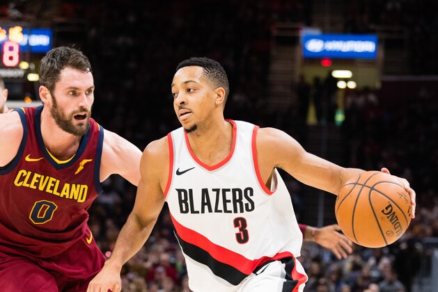 CLEVELAND, OH - JANUARY 2: Kevin Love #0 of the Cleveland Cavaliers tries to stop CJ McCollum #3 of the Portland Trail Blazers during the second half at Quicken Loans Arena on January 2, 2018 in Cleveland, Ohio. The Cavaliers defeated the Trail Blazers 127-110. NOTE TO USER: User expressly acknowledges and agrees that, by downloading and or using this photograph, User is consenting to the terms and conditions of the Getty Images License Agreement. (Photo by Jason Miller/Getty Images)