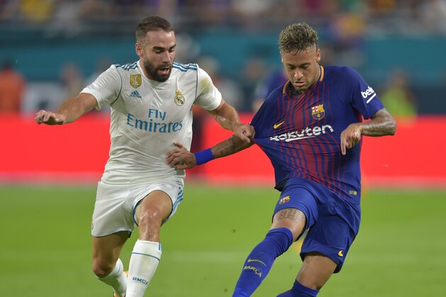 Daniel Carvajal (L) of Real Madrid chases Neymar (R) of Barcelona during their International Champions Cup football match at Hard Rock Stadium on July 29, 2017 in Miami, Florida.      / AFP PHOTO / HECTOR RETAMAL        (Photo credit should read HECTOR RETAMAL/AFP/Getty Images)