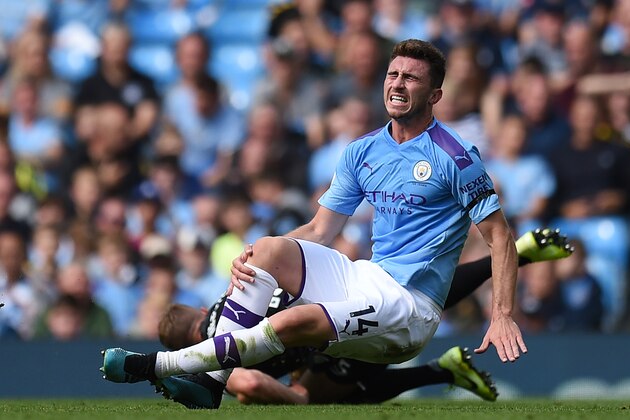 Manchester City's French defender Aymeric Laporte picks up an injury in a challenge with Brighton's English defender Adam Webster during the English Premier League football match between Manchester City and Brighton and Hove Albion at the Etihad Stadium in Manchester, north west England, on August 31, 2019. (Photo by Oli SCARFF / AFP) / RESTRICTED TO EDITORIAL USE. No use with unauthorized audio, video, data, fixture lists, club/league logos or 'live' services. Online in-match use limited to 120 images. An additional 40 images may be used in extra time. No video emulation. Social media in-match use limited to 120 images. An additional 40 images may be used in extra time. No use in betting publications, games or single club/league/player publications. /         (Photo credit should read OLI SCARFF/AFP/Getty Images)