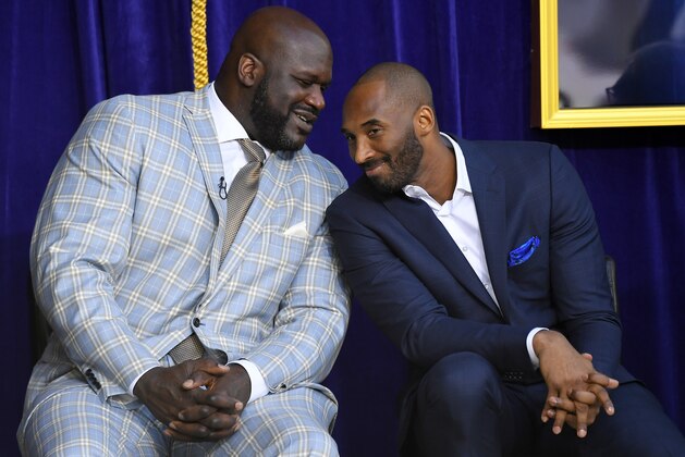FILE - In this March 24, 2017, file photo, Shaquille O'Neal, left, and Kobe Bryant chat at the unveiling of a statue of O'Neal in front of the Staples Center in Los Angeles. Bryant downplayed talk of a reignited feud with Shaquille O'Neal, saying there is