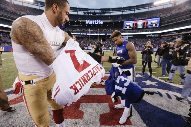 San Francisco 49ers quarterback Colin Kaepernick (7) and New York Giants wide receiver Odell Beckham (13) exchange jerseys after an NFL football game Sunday, Nov. 16, 2014, in East Rutherford, N.J. The 49ers won the game 16-10. (AP Photo/Julio Cortez)
