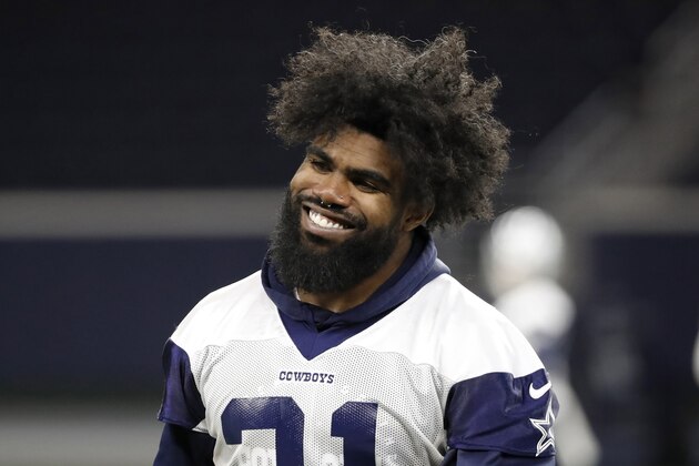 FILE - In this June 12, 2019, file photo, Dallas Cowboys running back Ezekiel Elliott smiles as he walks off the field after participating in drills at the team's NFL football training facility in Frisco, Texas. The Dallas Cowboys and Ezekiel Elliott have agreed on a $90 million, six-year contract extension that will make him the NFL's highest-paid running back and end a holdout that lasted the entire preseason, a person with knowledge of the agreement said Wednesday, Sept. 4, 2019. (AP Photo/Tony Gutierrez, File)
