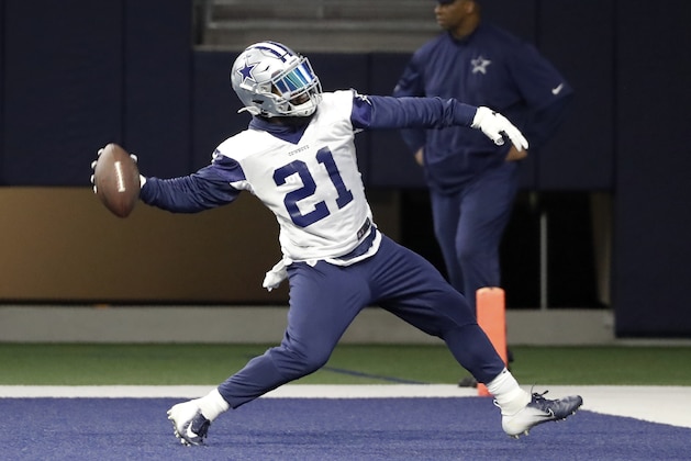 Dallas Cowboys running back Ezekiel Elliott (21) winds up to throw the ball at the wall after reaching the end zone during workouts at the team's NFL football training facility in Frisco, Texas, Thursday, June 13, 2019. (AP Photo/Tony Gutierrez