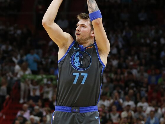 Dallas Mavericks forward Luka Doncic (77) shoots the ball against Miami Heat forward James Johnson (16) during the first half of an NBA basketball game, Thursday, March 28, 2019, in Miami. (AP Photo/Joel Auerbach)