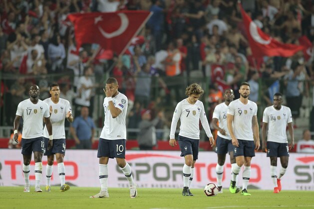 France's forward Antoine Griezmann, center right, and Kylian Mbappe, center left, walk back to the center circle after Turkey scored a goal during the Euro 2020 Group H qualifying soccer match between Turkey and France in Konya, Turkey, Saturday June 8, 2019. (AP Photo)