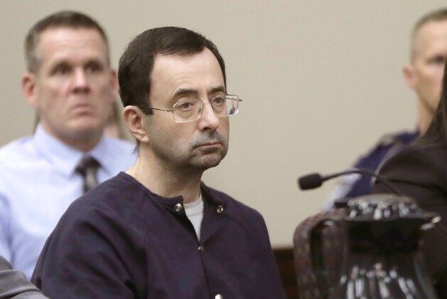 FILE - In this Jan. 24, 2018, file photo, Larry Nassar, a former doctor for USA Gymnastics and member of Michigan State's sports medicine staff, sits in court during his sentencing hearing in Lansing, Mich. Michigan State University said Thursday, Aug. 30, 2018, that the NCAA has cleared it of any rules violations in the Nassar sexual-assault scandal. Nassar pleaded guilty to assaulting girls and women while working as a campus sports doctor for Michigan State athletes and gymnasts in the region. (AP Photo/Carlos Osorio, File)