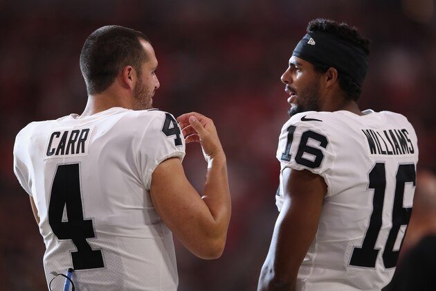 GLENDALE, ARIZONA - AUGUST 15:  Quarterback Derek Carr #4 and wide receiver Tyrell Williams #16 of the Oakland Raiders talk on the sidelines during the first half of the NFL preseason game against the Arizona Cardinals at State Farm Stadium on August 15, 2019 in Glendale, Arizona. (Photo by Christian Petersen/Getty Images)