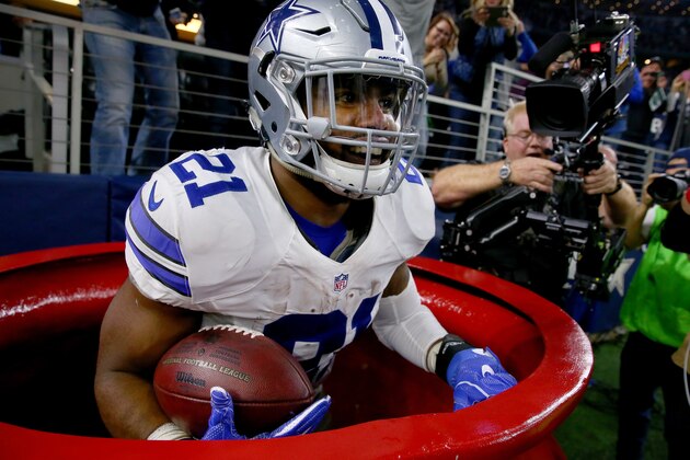 ARLINGTON, TX - DECEMBER 18:  Ezekiel Elliott #21 of the Dallas Cowboys celebrates after scoring a touchdown by jumping into a Salvation Army red kettle during the second quarter against the Tampa Bay Buccaneers at AT&T Stadium on December 18, 2016 in Arlington, Texas.  (Photo by Tom Pennington/Getty Images)