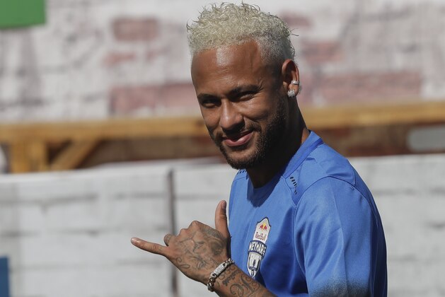 Brazilian soccer player Neymar flashes a
