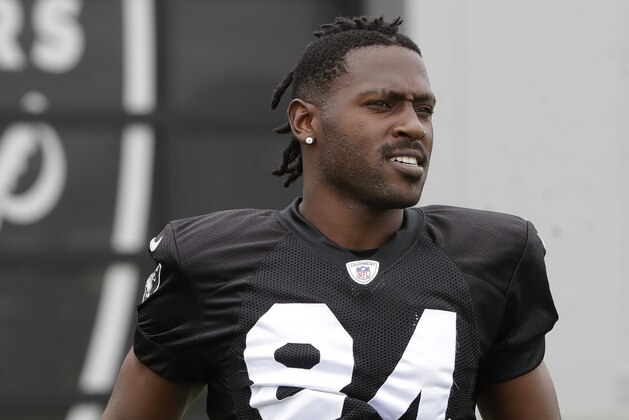 Oakland Raiders' Antonio Brown jogs onto the field before stretching during NFL football practice in Alameda, Calif., Tuesday, Aug. 20, 2019. (AP Photo/Jeff Chiu)