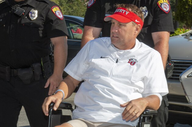 Liberty head football coach Hugh Freeze arrives to coach from a wheelchair in the coaches' box against Syracuse in an NCAA college football game in Lynchburg, Va., Saturday, Aug. 31, 2019. (AP Photo/Matt Bell) Liberty head football coach Hugh Freeze arrives to coach from a wheelchair in the coaches' box against Syracuse in an NCAA college football game in Lynchburg, Va., Saturday, Aug. 31, 2019. (AP Photo/Matt Bell)