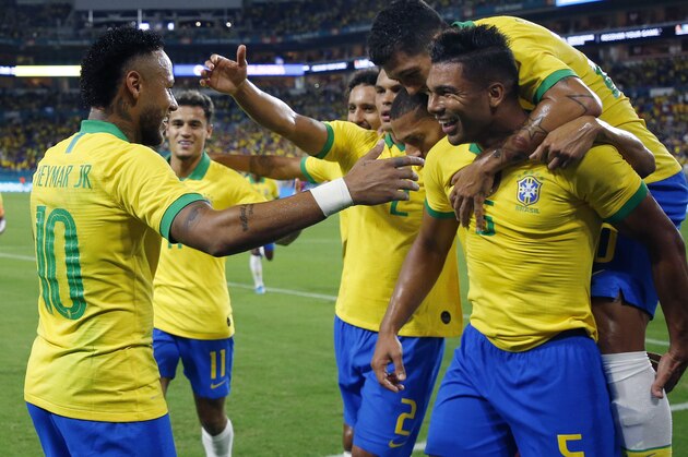 Brazil's foward Neymar Jr. (L) celebrates with teammates after scoring against Colombia during their international friendly football match between Brazil and Colombia at Hard Rock Stadium in Miami, Florida, on September 6, 2019. (Photo by RHONA WISE / AFP)        (Photo credit should read RHONA WISE/AFP/Getty Images)