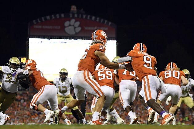 CLEMSON, SOUTH CAROLINA - AUGUST 29: Quarterback Trevor Lawrence #16 hands off the football to running back Travis Etienne #9 of the Clemson Tigers during their football game against the Georgia Tech Yellow Jackets at Memorial Stadium on August 29, 2019 in Clemson, South Carolina. (Photo by Mike Comer/Getty Images)