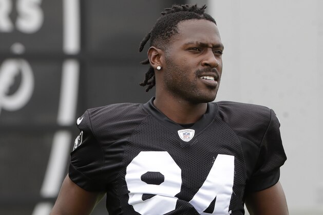 Oakland Raiders' Antonio Brown jogs onto the field before stretching during NFL football practice in Alameda, Calif., Tuesday, Aug. 20, 2019. (AP Photo/Jeff Chiu)