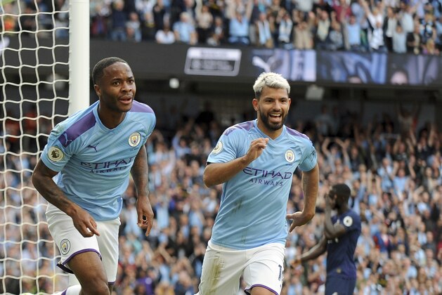 Manchester City's Raheem Sterling, left, celebrates with Manchester City's Sergio Aguero after scoring his side's opening goal during the English Premier League soccer match between Manchester City and Tottenham Hotspur at Etihad stadium in Manchester, England, Saturday, Aug. 17, 2019. (AP Photo/Rui Vieira)