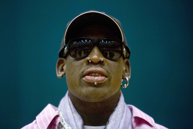 FILE - In this Dec. 20, 2013, file photo, former NBA basketball star Dennis Rodman leaves a sports arena after a practice session for North Korean basketball players in Pyongyang, North Korea. North Korea's Foreign Ministry official who spoke to the AP in Pyongyang confirmed Rodman was expected to arrive Tuesday, June 13, 2017, but could not provide details. (AP Photo/David Guttenfelder, File)