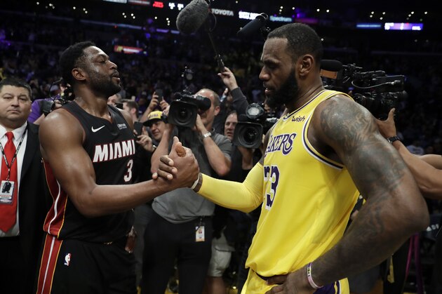 Miami Heat guard Dwyane Wade, left, shakes hands with Los Angeles Lakers' LeBron James at the end of an NBA basketball game Monday, Dec. 10, 2018, in Los Angeles. (AP Photo/Marcio Jose Sanchez)