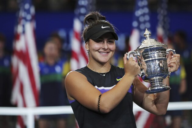 Bianca Andreescu, of Canada, holds up the championship trophy after defeating Serena Williams, of the United States, in the women's singles final of the U.S. Open tennis championships Saturday, Sept. 7, 2019, in New York. (AP Photo/Charles Krupa)