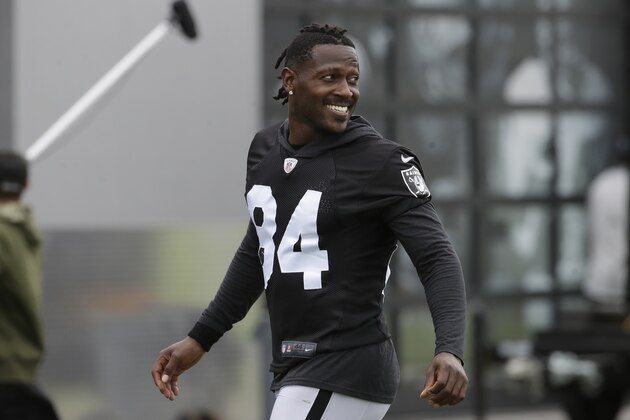 FILE - In this Aug. 20, 2019 file photo, Oakland Raiders' Antonio Brown smiles before stretching during NFL football practice in Alameda, Calif.  Brown was released by the Raiders,  Saturday, Sept. 7, 2019.  (AP Photo/Jeff Chiu, File)