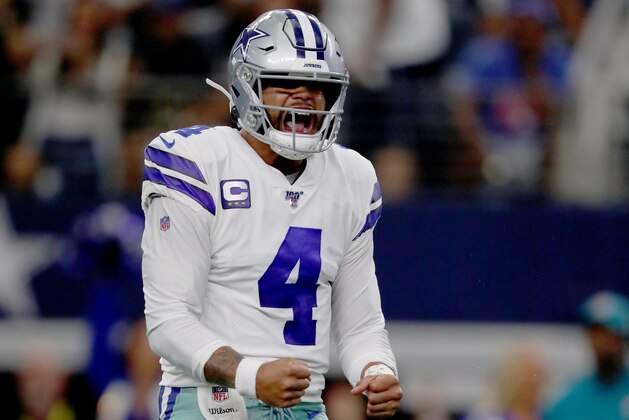 ARLINGTON, TEXAS - SEPTEMBER 08: Quarterback Dak Prescott #4 of the Dallas Cowboys celebrates after connecting with Ezekiel Elliott #21 of the Dallas Cowboys to score a touchdown in the third quarter of the game against the New York Giants at AT&T Stadium on September 08, 2019 in Arlington, Texas. (Photo by Tom Pennington/Getty Images)