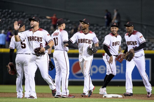 PHOENIX, ARIZONA - AUGUST 19: David Peralta #6, Nick Ahmed #13, Jarrod Dyson #1, Ketel Marte #4 and Adam Jones #10 of the Arizona Diamondbacks celebrate after defeating the Colorado Rockies 5-3 at Chase Field on August 19, 2019 in Phoenix, Arizona. T (Photo by Jennifer Stewart/Getty Images)