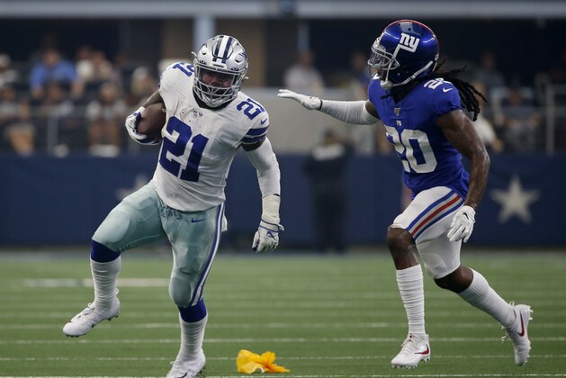 Dallas Cowboys running back Ezekiel Elliott (21) runs the ball as New York Giants cornerback Janoris Jenkins (20) defends in the first half of a NFL football game in Arlington, Texas, Sunday, Sept. 8, 2019. (AP Photo/Ron Jenkins)