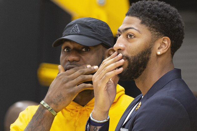 Los Angeles Lakers NBA basketball players, LeBron James, left, and Anthony Davis share a moment after David was introduced at a news conference at the UCLA Health Training Center in El Segundo, Calif., Saturday, July 13, 2019. (AP Photo/Damian Dovarganes)