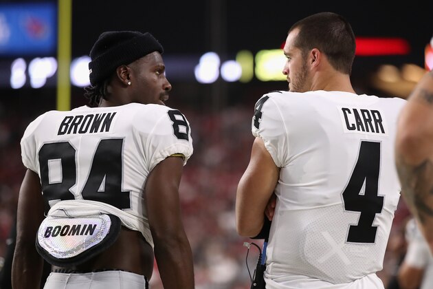 GLENDALE, ARIZONA - AUGUST 15:  Wide receiver Antonio Brown #84 and quarterback Derek Carr #4 of the Oakland Raiders talk on the sidelines during the first half of the NFL preseason game against the Arizona Cardinals at State Farm Stadium on August 15, 2019 in Glendale, Arizona. (Photo by Christian Petersen/Getty Images)