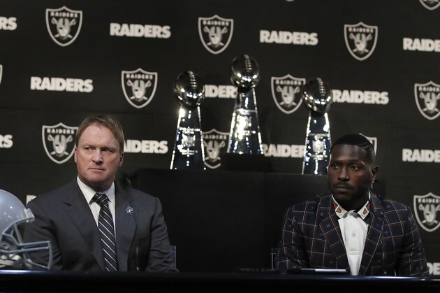 Oakland Raiders coach Jon Gruden, left, and wide receiver Antonio Brown listen to questions from the media during an NFL football news conference, Wednesday, March 13, 2019, in Alameda, Calif. (AP Photo/Ben Margot)