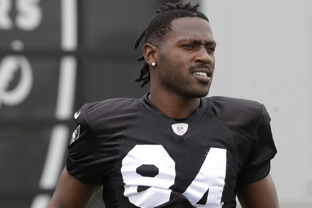 Oakland Raiders' Antonio Brown jogs onto the field before stretching during NFL football practice in Alameda, Calif., Tuesday, Aug. 20, 2019. (AP Photo/Jeff Chiu)
