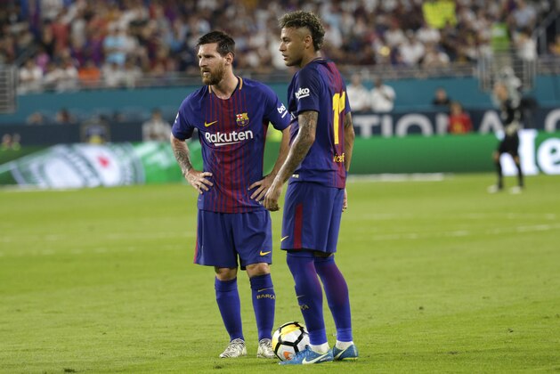 Barcelona's Lionel Messi, left, and Neymar, right, stand on the field during a break in the action during the first half of an International Champions Cup soccer match against Real Madrid, Saturday, July 29, 2017, in Miami Gardens, Fla. (AP Photo/Lynne Sladky)