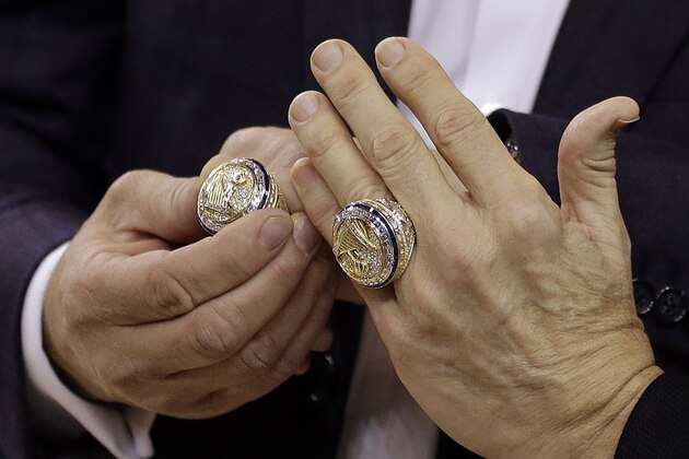 The hands of Golden State Warriors co-owners Joe Lacob, left, and Peter Guber display their NBA championship rings during a ring ceremony prior to the basketball game against the Houston Rockets Tuesday, Oct. 17, 2017, in Oakland, Calif. (AP Photo/Ben Margot) The hands of Golden State Warriors co-owners Joe Lacob, left, and Peter Guber display their NBA championship rings during a ring ceremony prior to the basketball game against the Houston Rockets Tuesday, Oct. 17, 2017, in Oakland, Calif. (AP Photo/Ben Margot)