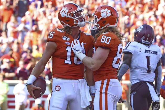 Clemson's Trevor Lawrence (10) and Luke Price celebrate Lawrence's touchdown during the first half of an NCAA college football game against Texas A&M Saturday, Sept. 7, 2019, in Clemson, S.C. (AP Photo/Richard Shiro)