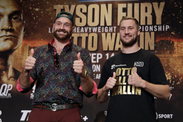 Tyson Fury, left, and Otto Wallin, of Sweden, pose for photos following a news conference Wednesday, Sept. 11, 2019, in Las Vegas. The pair will face each other in a heavyweight boxing match Saturday. (AP Photo/Isaac Brekken)