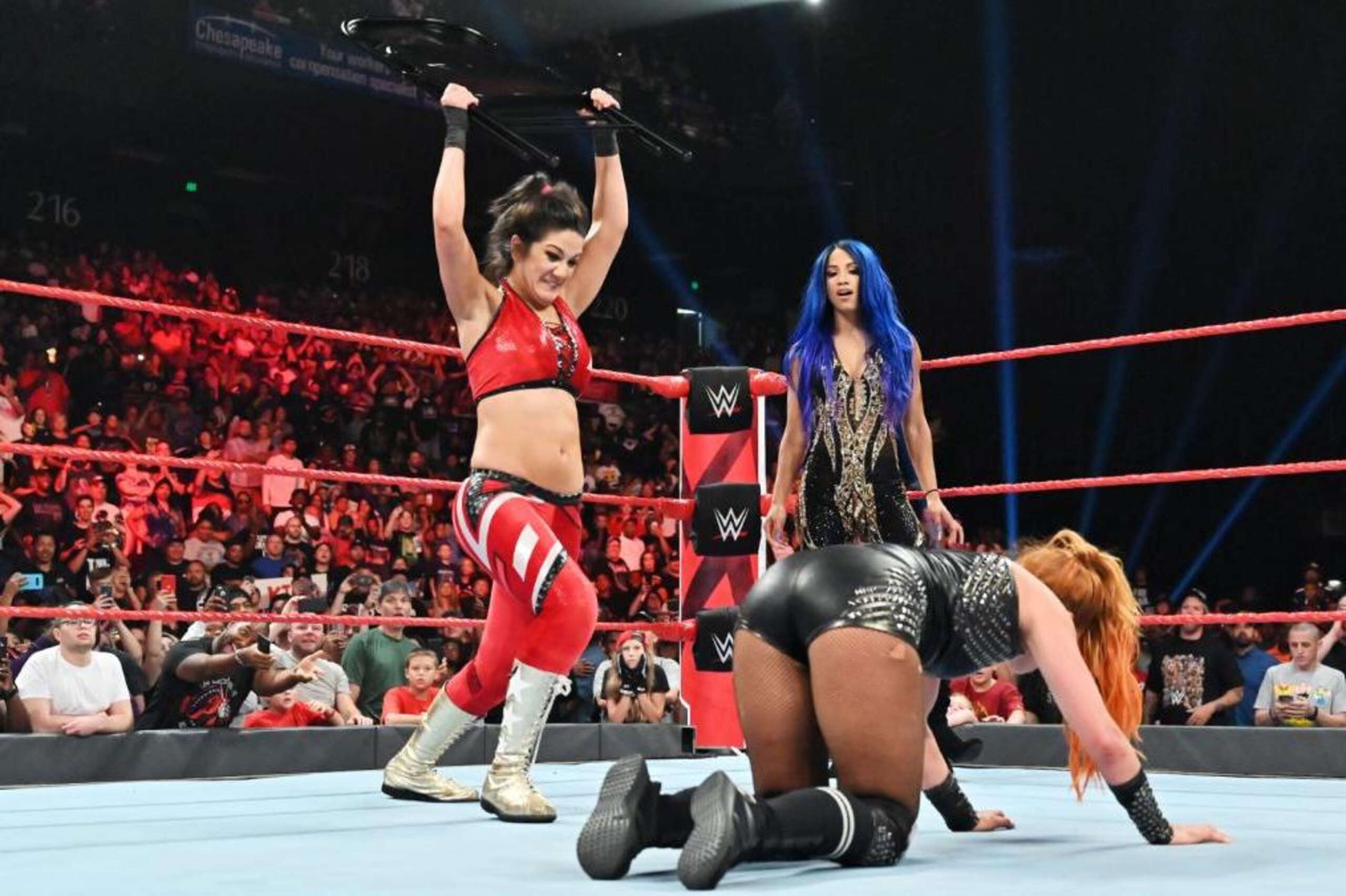 Bayley and Sasha Banks attacking Becky Lynch.