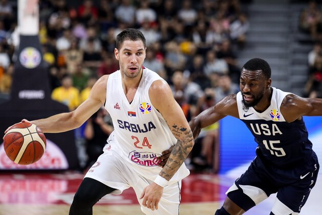 DONGGUAN, CHINA - SEPTEMBER 12: #24 Stefan Jovic of Serbia drives as #15 Kemba Walker of USA defends during the games 5-8 of 2019 FIBA World Cup between Serbia and USA at Dongguan Basketball Center on September 12, 2019 in Dongguan, China. (Photo by Zhizhao Wu/Getty Images)