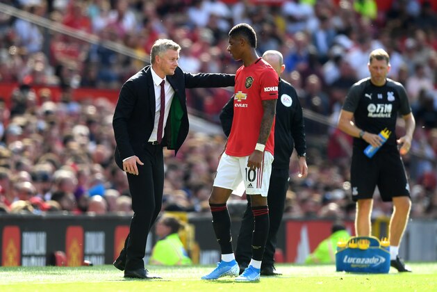 MANCHESTER, ENGLAND - AUGUST 24: Marcus Rashford of Manchester United talks to manager Ole Gunnar Solskjaer during the Premier League match between Manchester United and Crystal Palace at Old Trafford on August 24, 2019 in Manchester, United Kingdom. (Photo by Michael Regan/Getty Images)