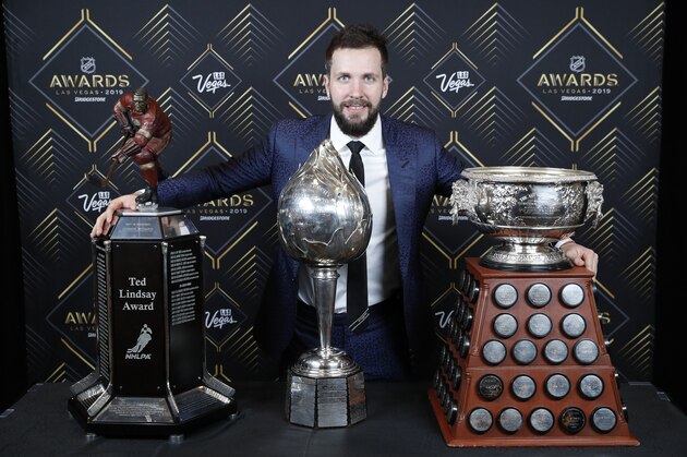 Tampa Bay Lightning's Nikita Kucherov poses with, from left, the Ted Lindsay Award, Hart Memorial Trophy and the Art Ross Trophy after winning the honors at the NHL Awards, Wednesday, June 19, 2019, in Las Vegas. (AP Photo/John Locher)