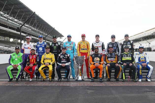 INDIANAPOLIS, INDIANA - SEPTEMBER 08: Ryan Newman, driver of the #6 Acorns Ford, Kyle Larson, driver of the #42 McDonald's Chevrolet, Erik Jones, driver of the #20 STANLEY Wish For Our Heros Toyota, William Byron, driver of the #24 Liberty University Chevrolet, Martin Truex Jr, driver of the #19 AOI Toyota, Clint Bowyer, driver of the #14 Rush/Cummins Ford, Ryan Blaney, driver of the #12 Wabash National Ford, Chase Elliott, driver of the #9 NAPA AUTO PARTS Chevrolet, Denny Hamlin, driver of the #11 FedEx Express Toyota, Alex Bowman, driver of the #88 Nationwide Chevrolet, Kurt Busch, driver of the #1 Monster Energy Chevrolet, Kyle Busch, driver of the #18 M&M's Toyota, Joey Logano, driver of the #22 Shell Pennzoil Ford, Brad Keselowski, driver of the #2 Discount Tire Ford, Kevin Harvick, driver of the #4 Mobil 1 Ford, Aric Almirola, driver of the #10 Smithfield/Meijer Ford, pose for a photo with the Monster Energy NASCAR Cup Series trophy to start the playoffs following the Monster Energy NASCAR Cup Series Bi