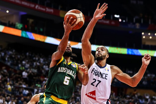NANJING, CHINA - SEPTEMBER 09: Patty Mills(L) #5 of Australia drives against Rudy Gobert #27 of France during 2nd round Group L match between Australia and France of 2019 FIBA World Cup at Nanjing Youth Olympic Sports Park Gymnasium on September 09, 2019 in Nanjing, China. (Photo by Shi Tang/Getty Images)
