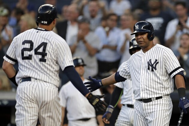 NEW YORK, NY - SEPTEMBER 3: Gary Sanchez #24 of the New York Yankees is congratulated after hitting a two run home run by Edwin Encarnacion #30  during the first against the Texas Rangers inning at Yankee Stadium on September 3, 2019 in the Bronx borough of New York City. (Photo by Adam Hunger/Getty Images)